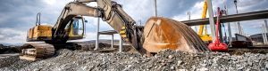 Heavy duty industrial excavator loading gravel on construction site. Details of building site