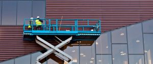 Builder on a Scissor Lift Platform at a construction site