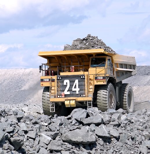 A Mega truck carrying load of rocks at a mining site