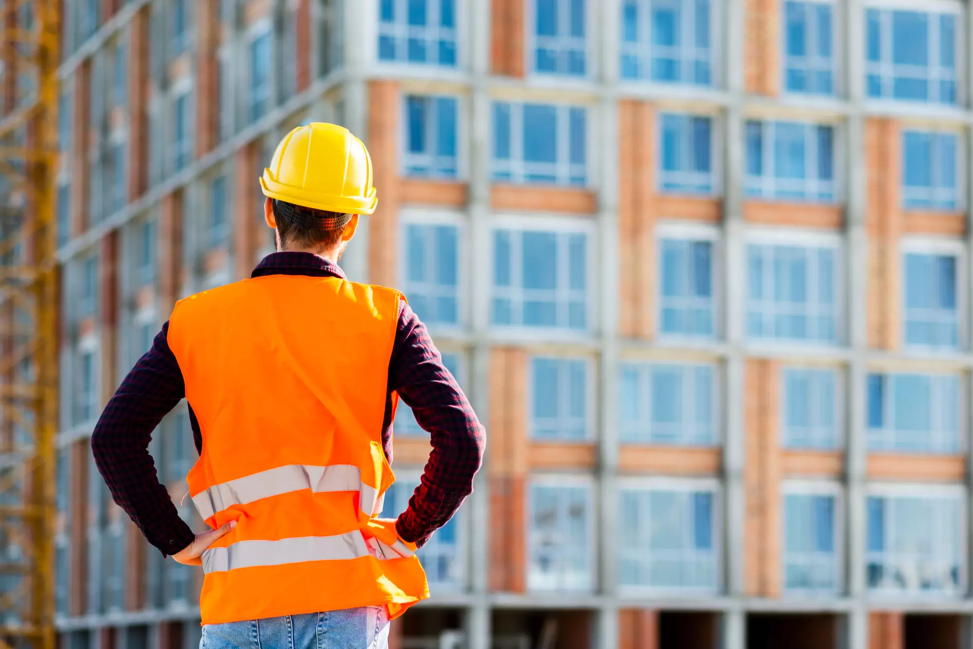 A Construction Worker standing in front of a site.