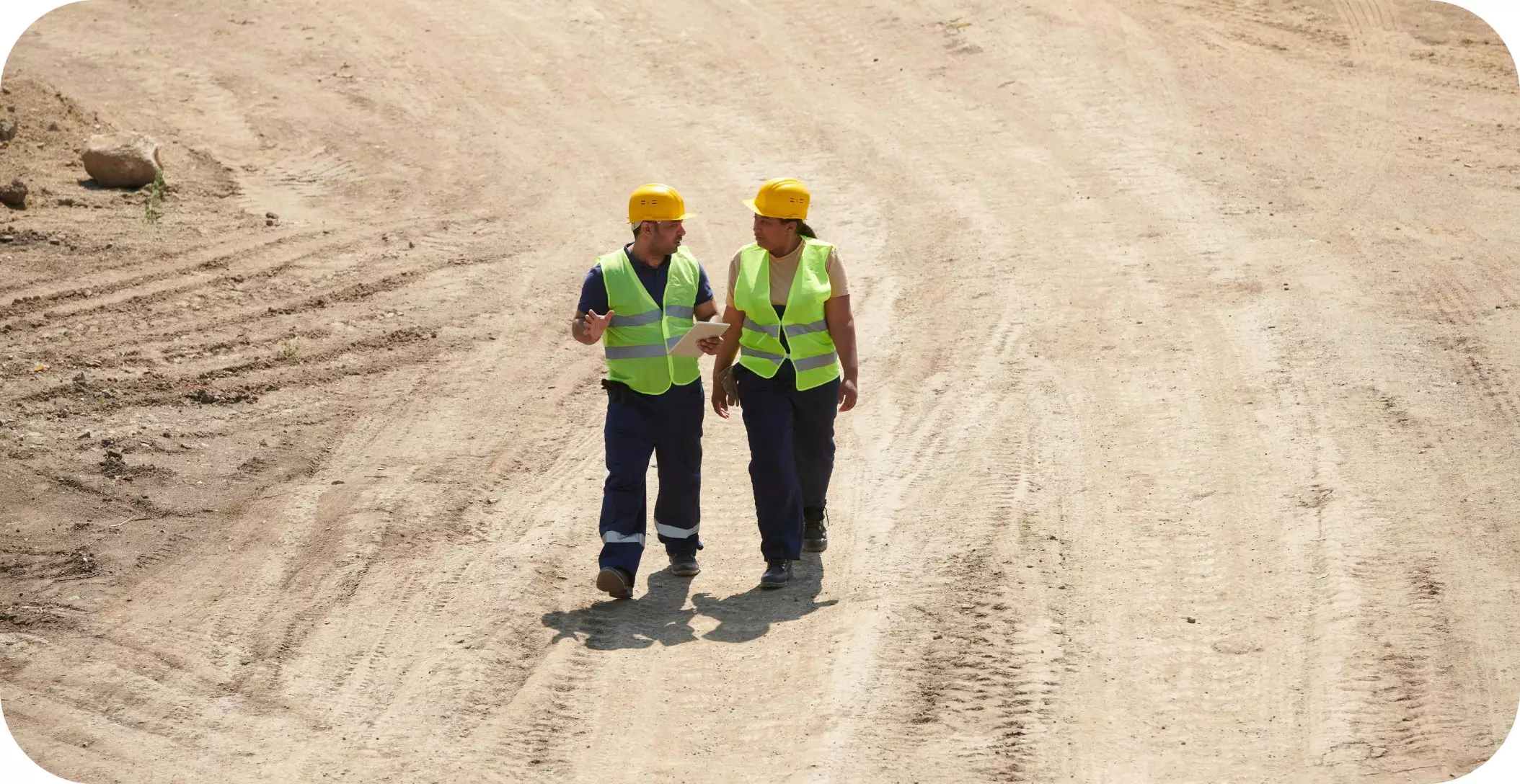 Two construction workers reviewing a construction site.