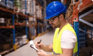 Worker using a digital equipment compliance checklist on a tablet, symbolizing that real safety relies on shared responsibility, open communication, and empowered teams—not just rules or roles.
