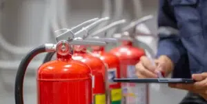 Fire safety equipment inspection in progress highlighting proactive risk management through hazard ID software.