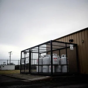 Outdoor propane cylinder reminding workers of safe transport and storage rules.