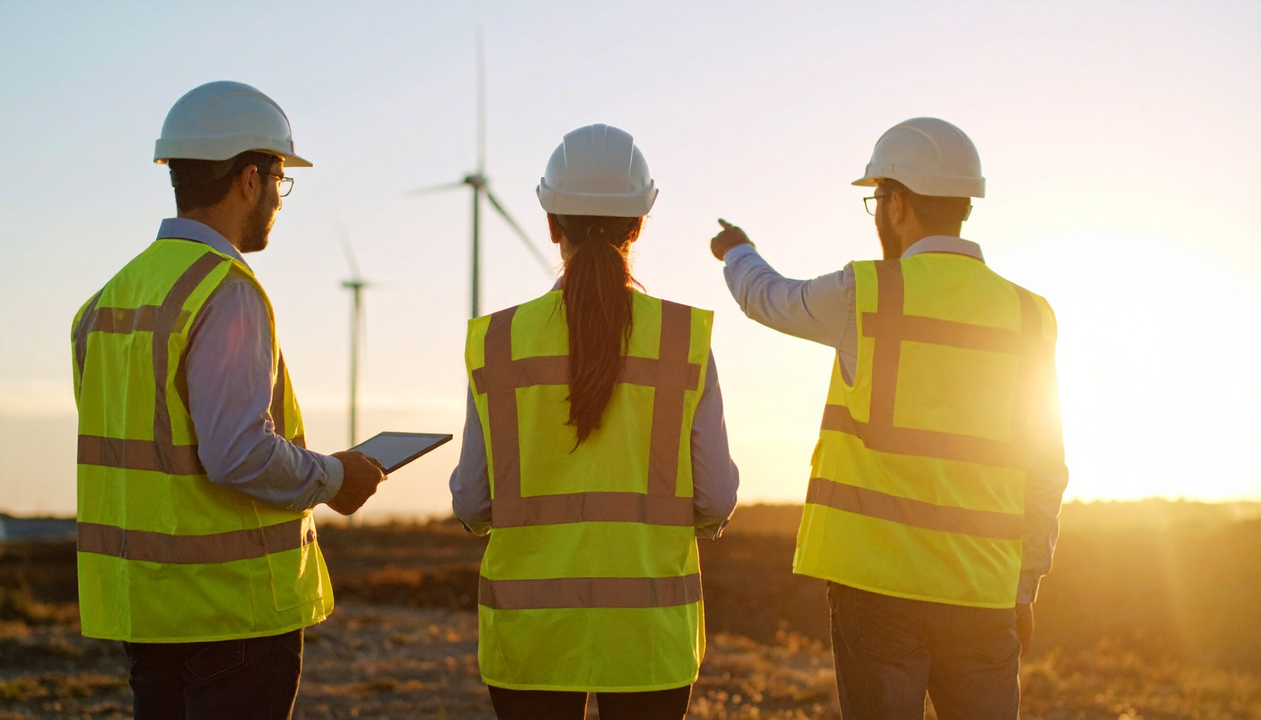 Worksite crew assessing potential hazards and planning a pause to protect team safety.