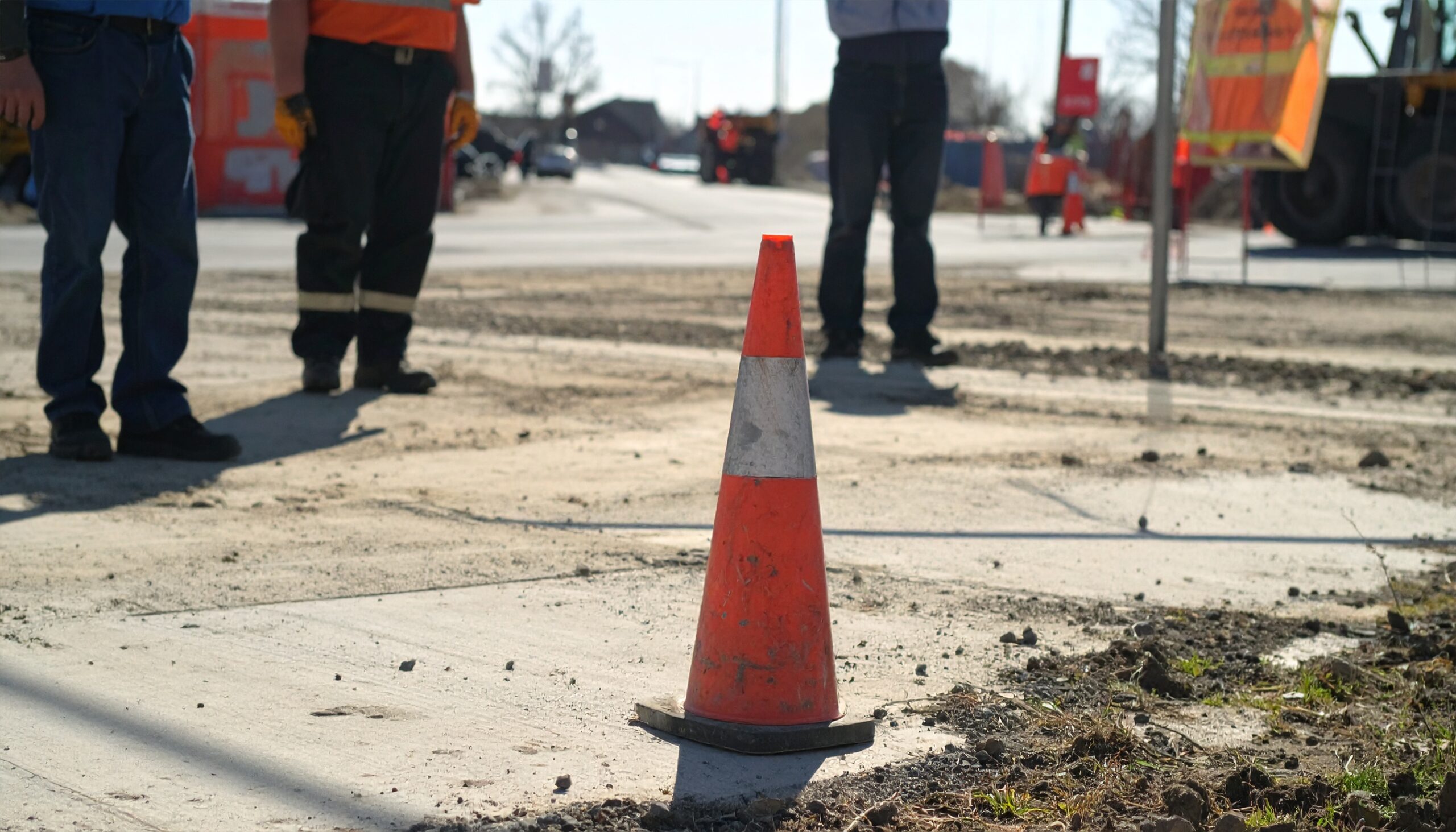 Construction zone safety cone indicating workers should halt operations to avoid hazards.