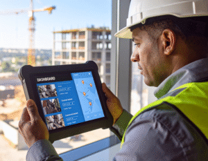 Industrial team using real-time reporting tools to track and manage safety risks through mobile and desktop systems.