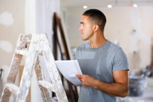 Lone worker reviewing safety procedures on a tablet, underscoring communication and check-in plans.