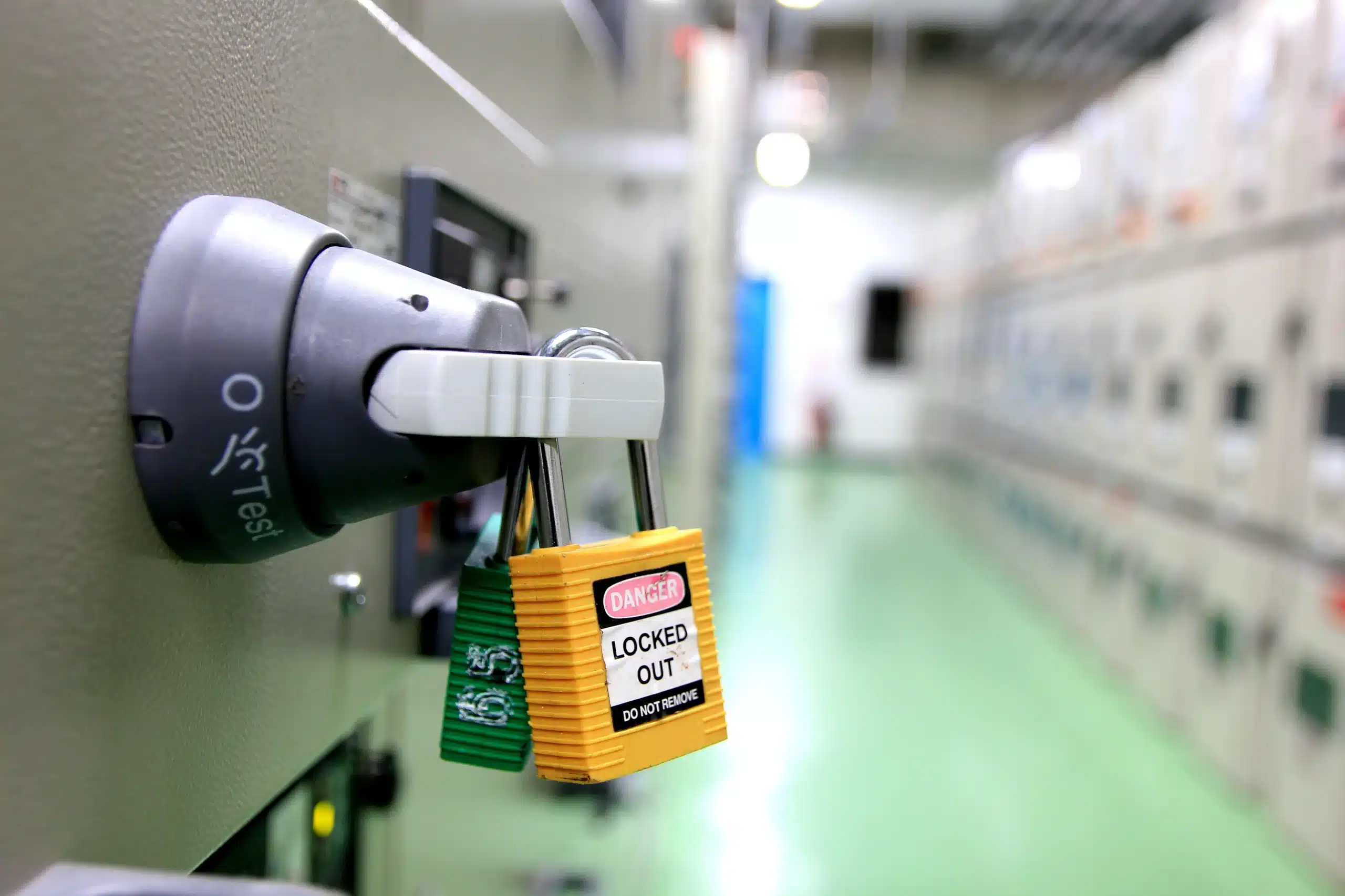 Group lockout on an electrical isolation point, showing several personal safety padlocks at a switch