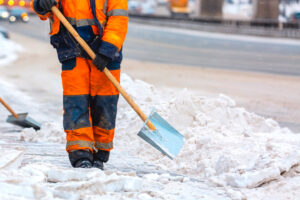 Clearing snow from paths to reduce ice buildup and same‑level slip, trip, and fall risks.