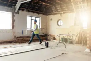 Lone construction worker operating in an unfinished building to highlight the need for safety procedures.