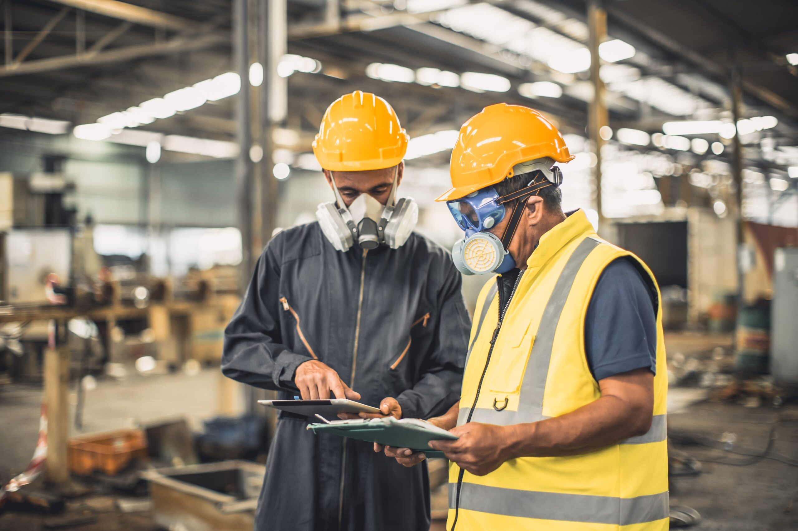 Worker wearing a safety mask and hard hat to protect against hazardous workplace gases.