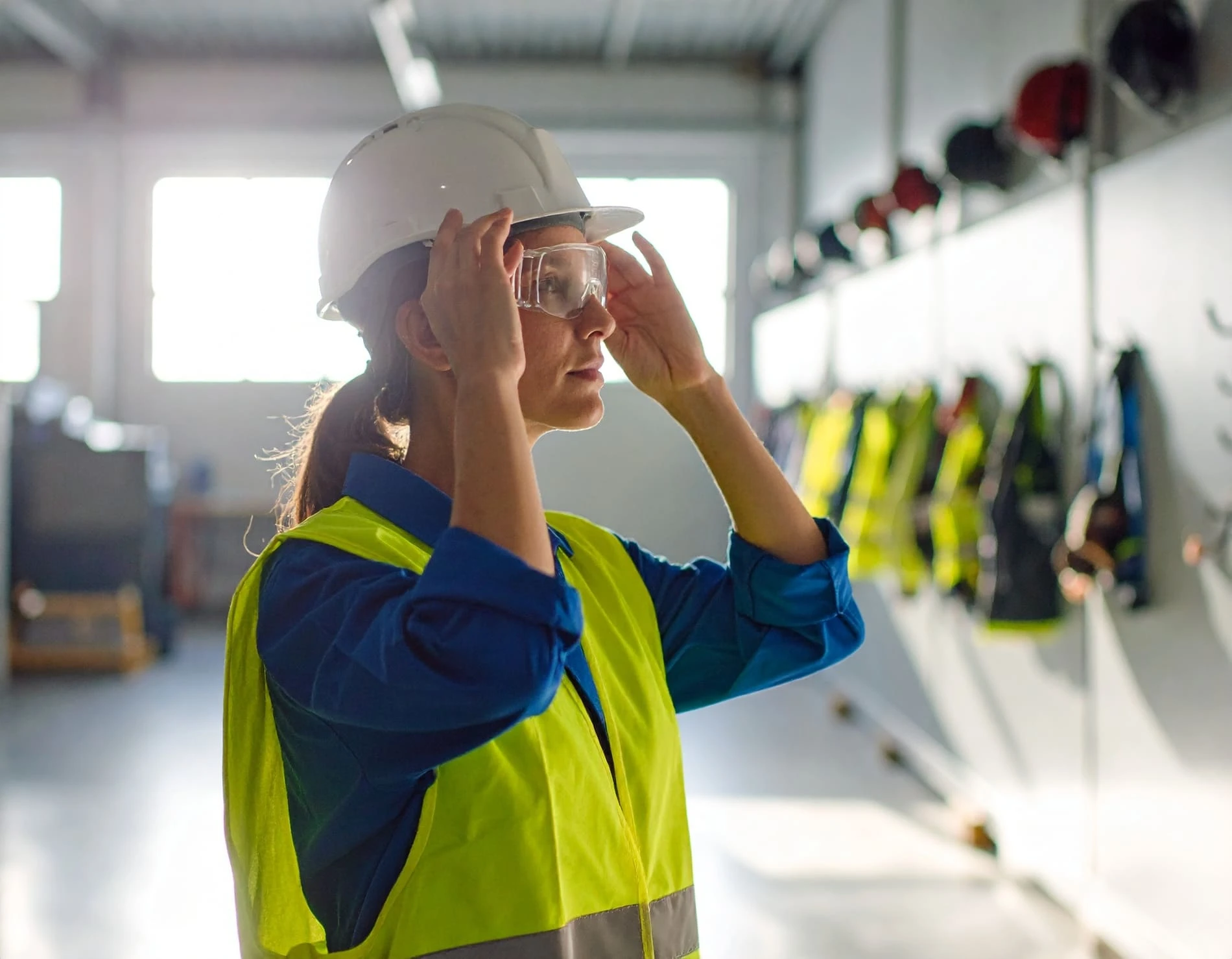 Group of construction workers reviewing digital safety checklists and inspection results on a tablet.
