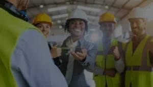 Supervisor and crew in PPE reviewing recognition results on a digital tablet together.