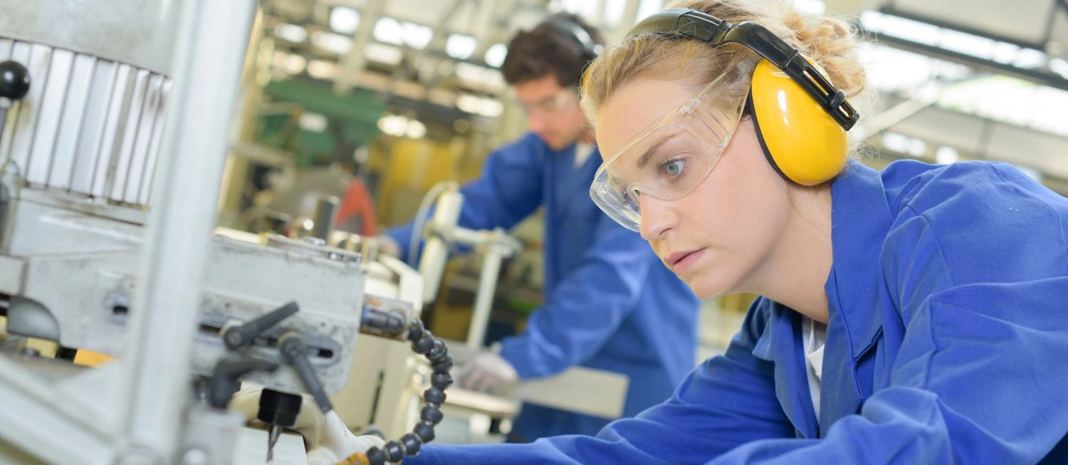 Woman using industrial machine