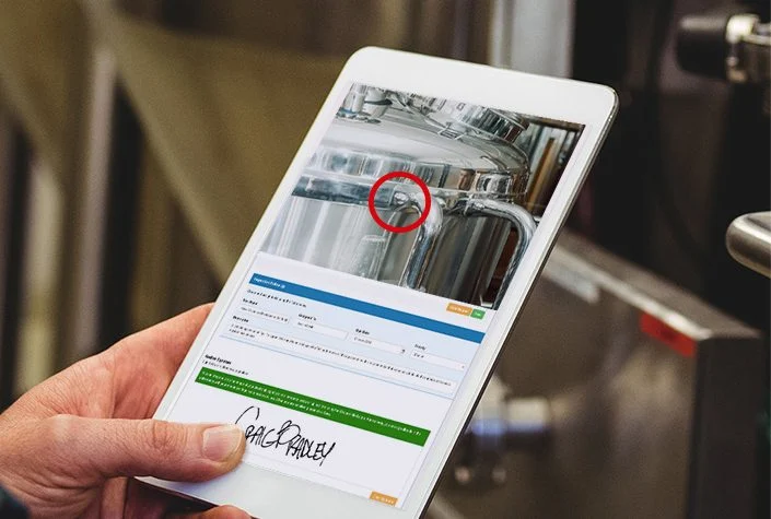 Man in brewery with inspection tablet Image for COR landing page smaller