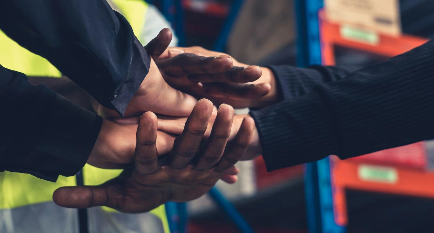 - BIS Safety Software Canada Factory workers stacking hands together in warehouse or storehouse . Logistics , supply chain and warehouse business concept .